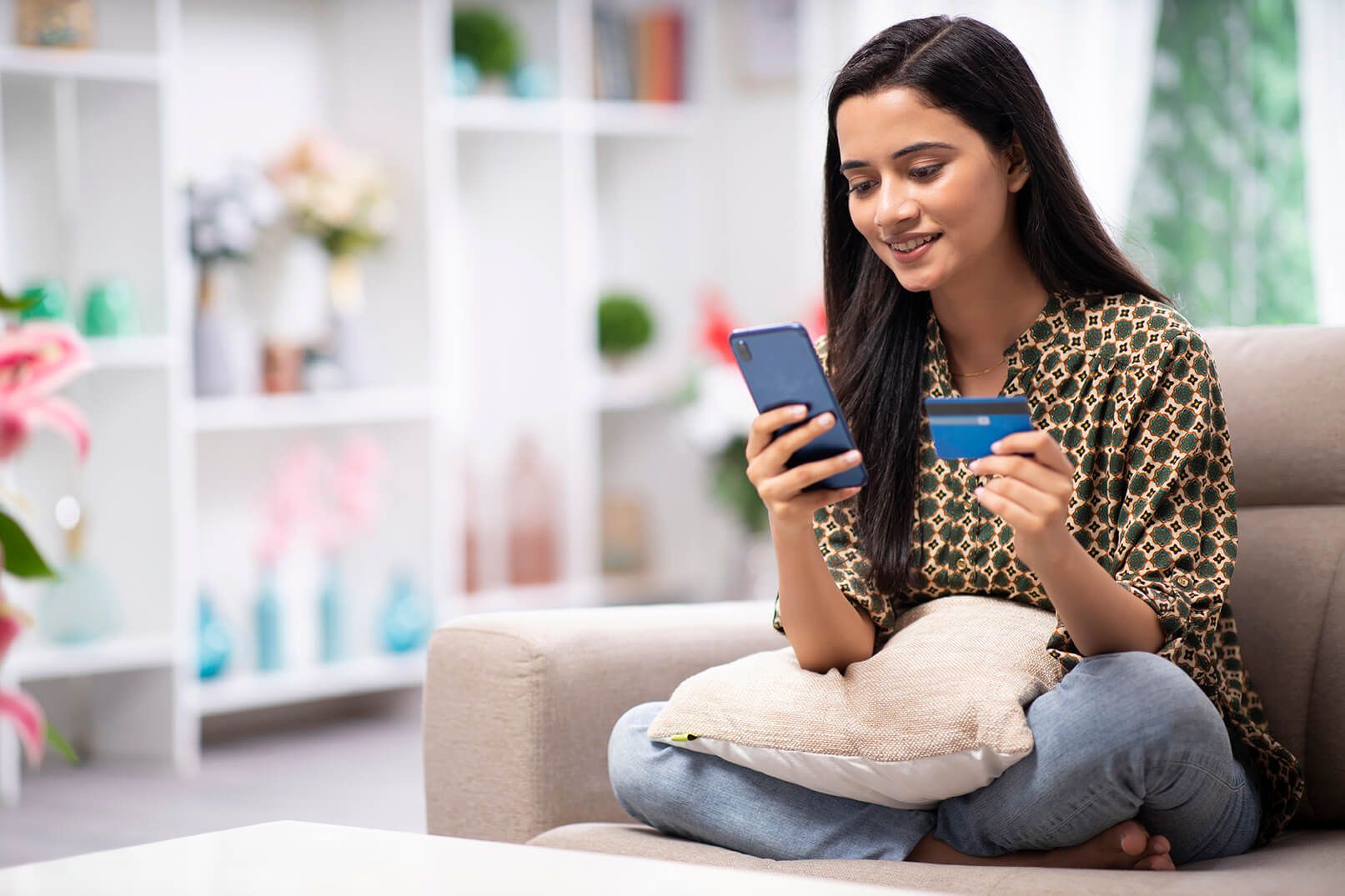 woman holding phone and card