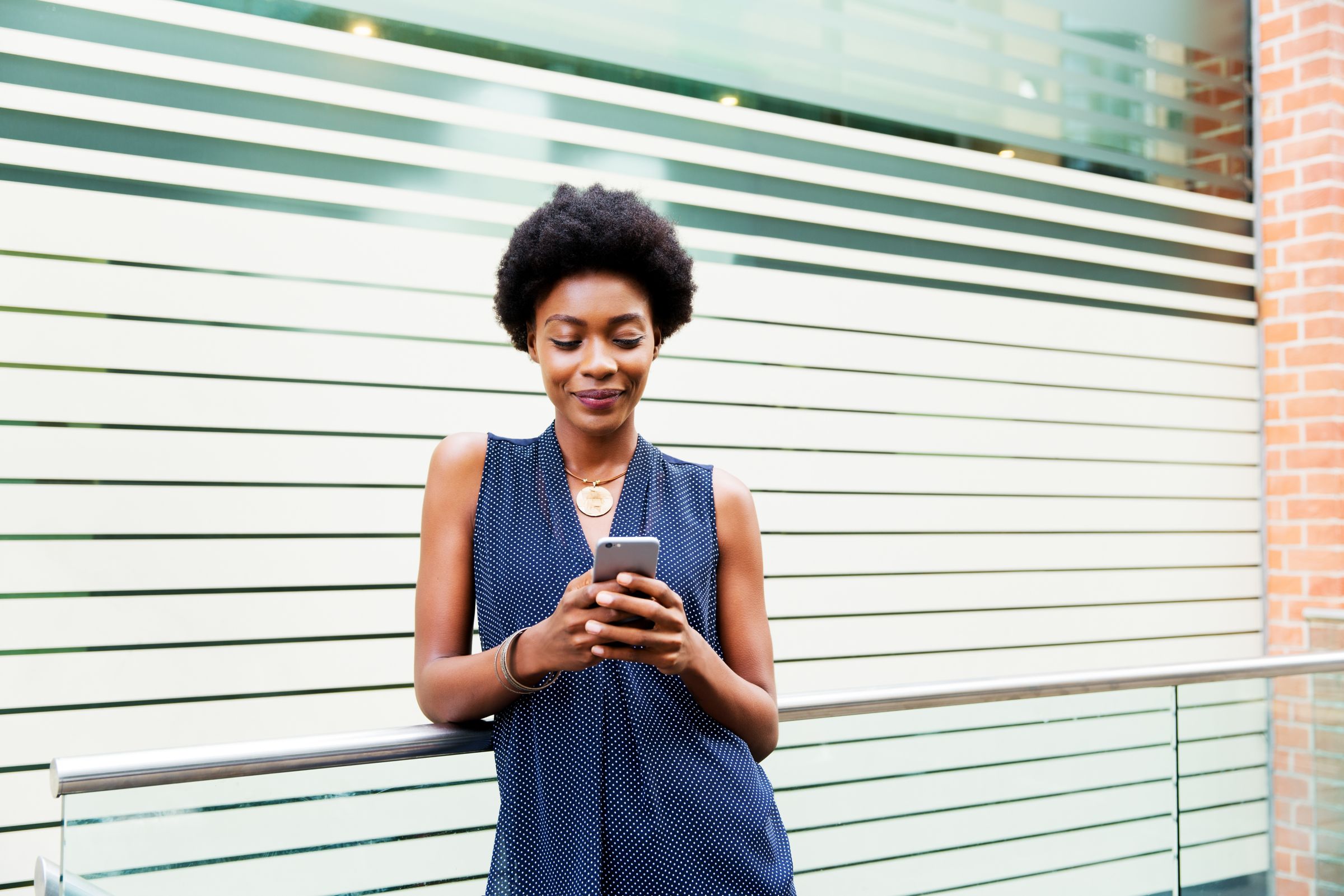 Women typing on mobile device