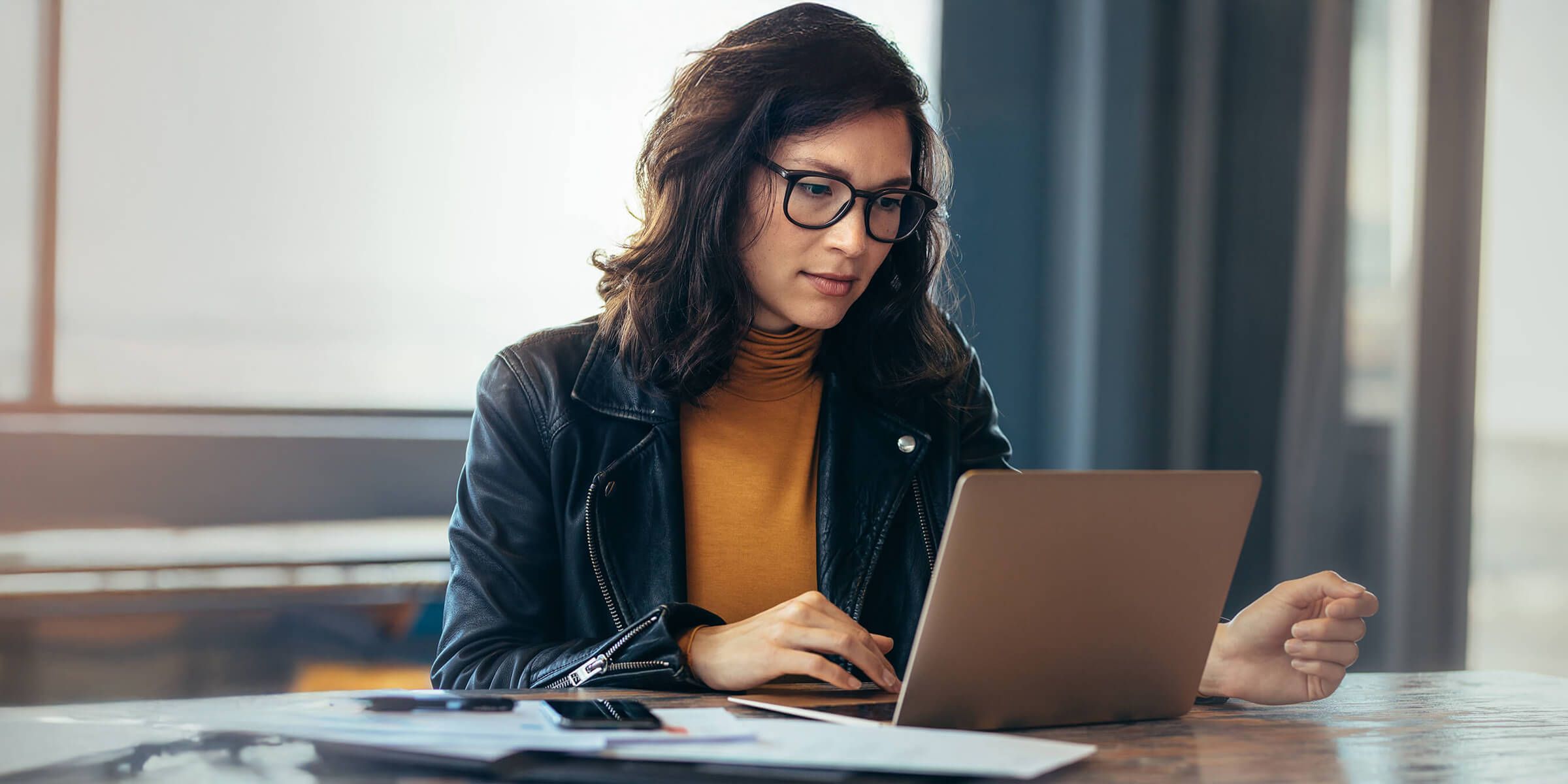 women sitting at laptop working