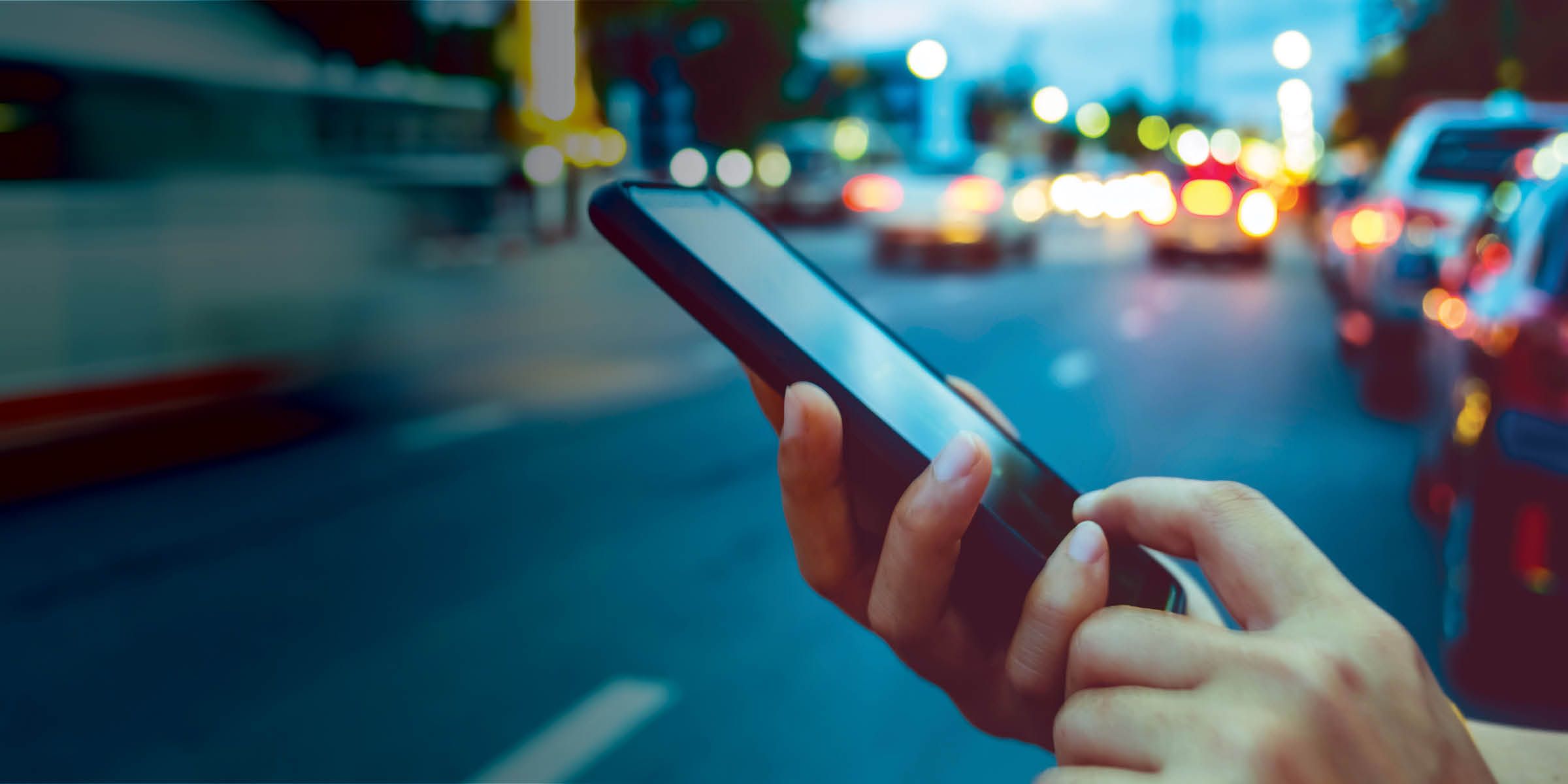 a person’s hand holding a phone