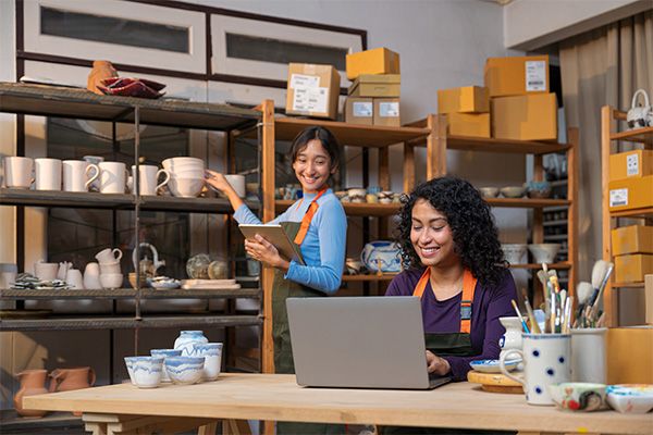woman smiling while working on a laptop