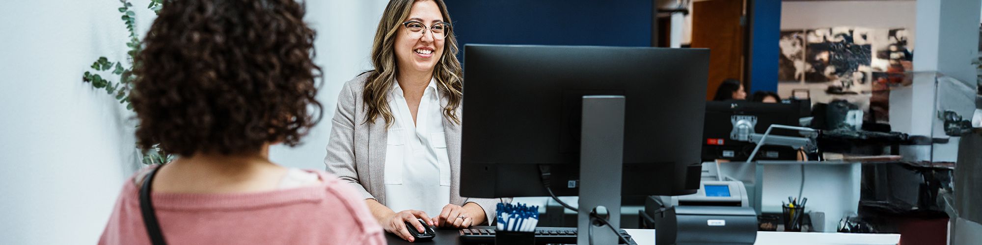 smiling lady working at a computer