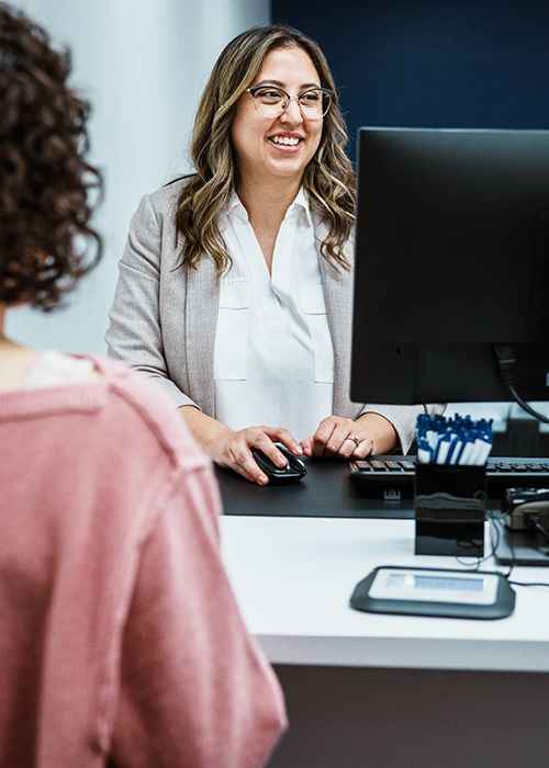 smiling lady working at a computer