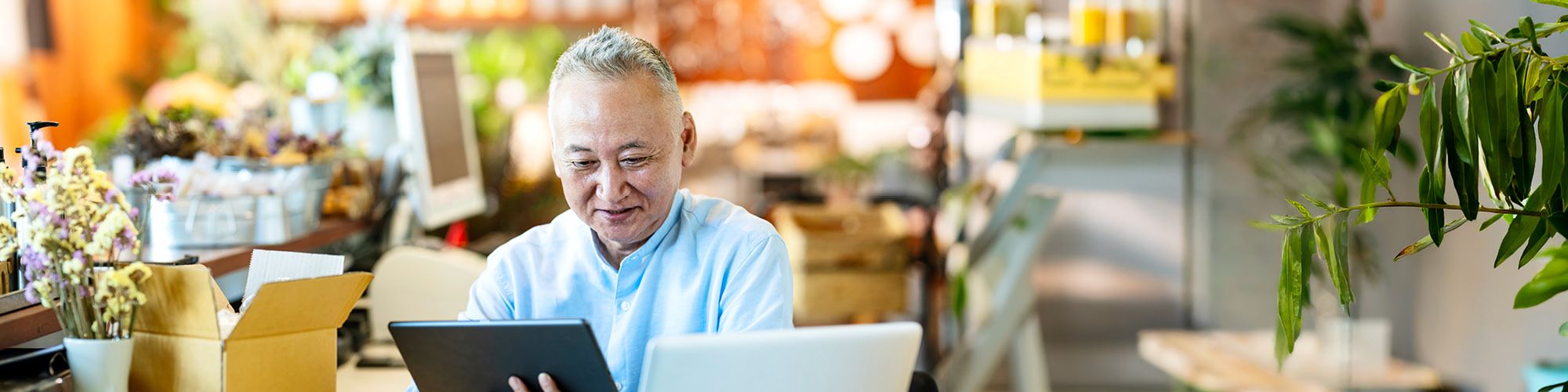 man looking at tablet and laptop
