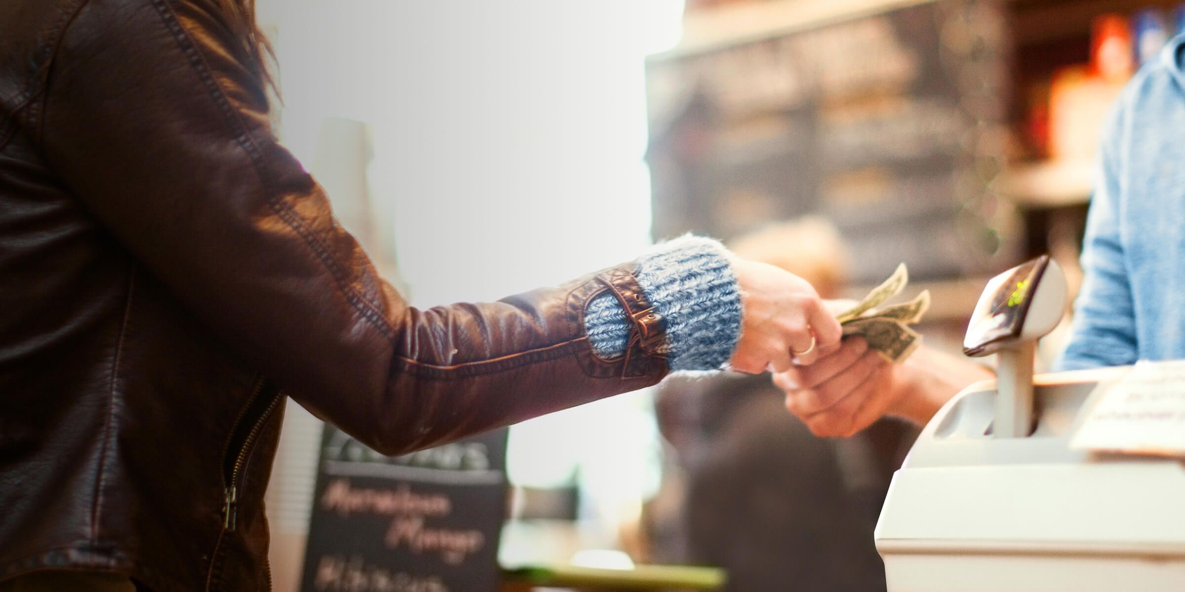 a person handing money to another person