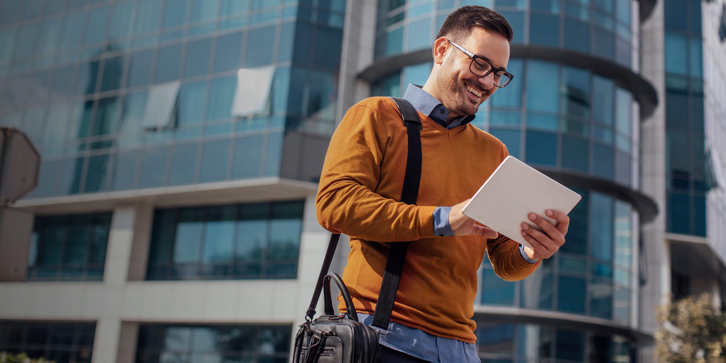 Man smiling looking at tablet