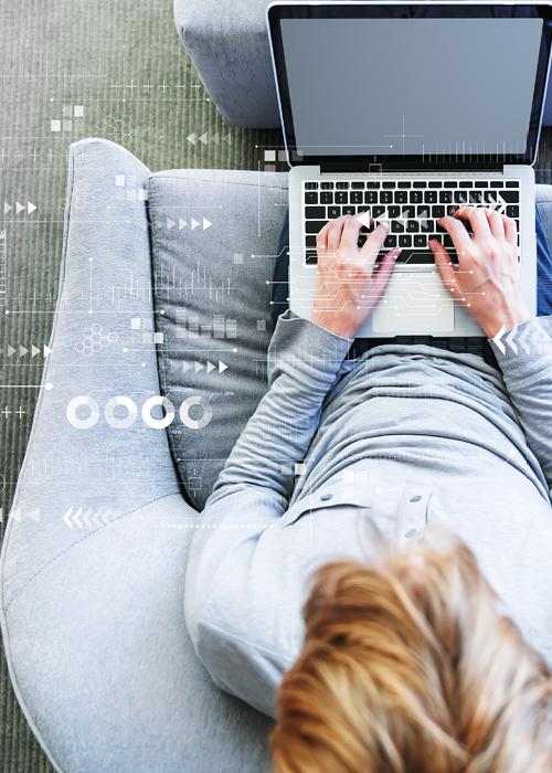 Man sitting typing on laptop with API graphic overlay