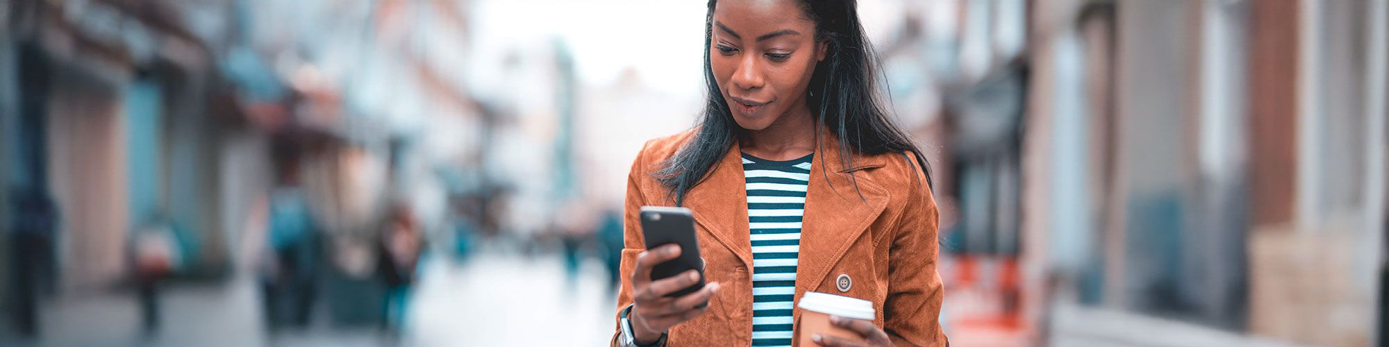 Woman banking by mobile device