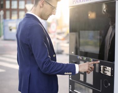 Person paying for parking at a kiosk